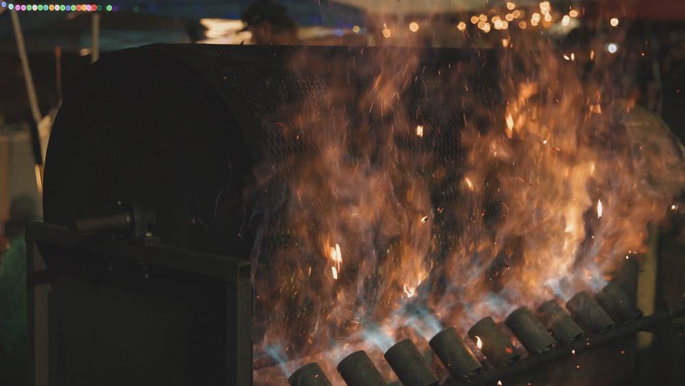 Flames and sparks erupt from a commercial chile roaster at the Pueblo Chile and Frijoles Festival